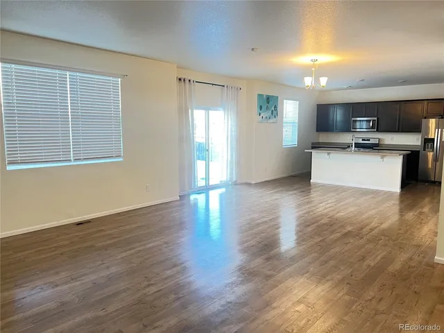 a view of kitchen with cabinets and wooden floor