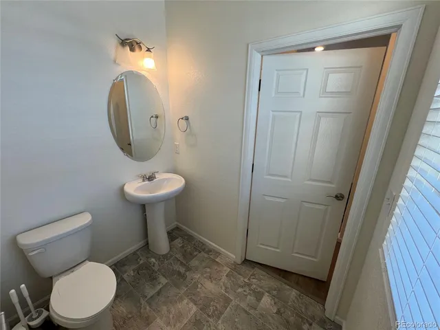 a bathroom with a toilet sink and a mirror