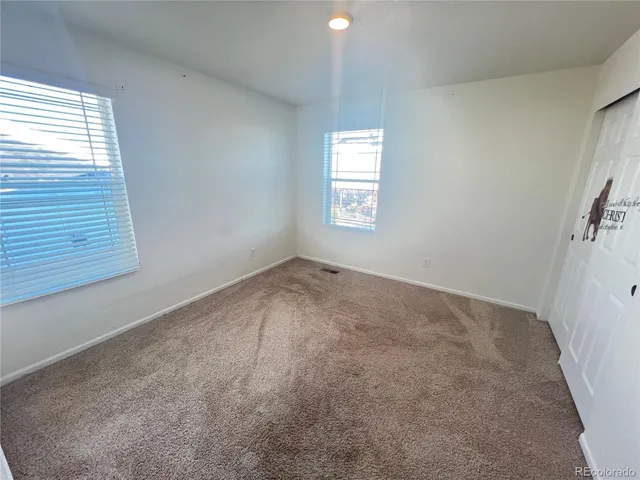 a view of an empty room and a window