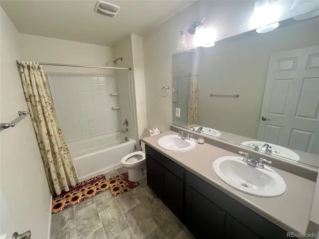 a bathroom with a tub sink toilet and mirror