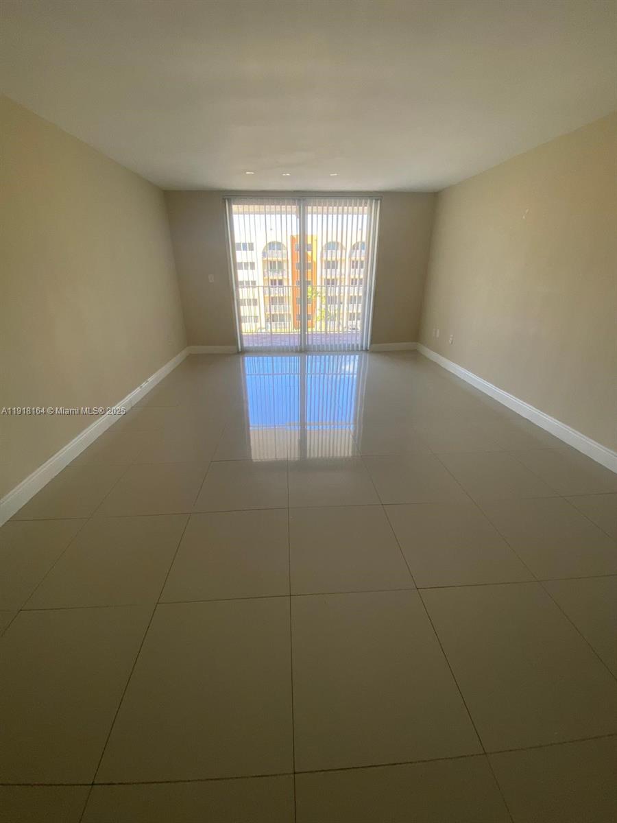 6970 Northwest 186th Street, Unit 3410 Hialeah, FL 33015 - Photo 1 of 10 a view of an empty room with a window