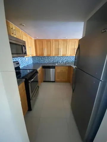 a kitchen with a sink appliances and cabinets