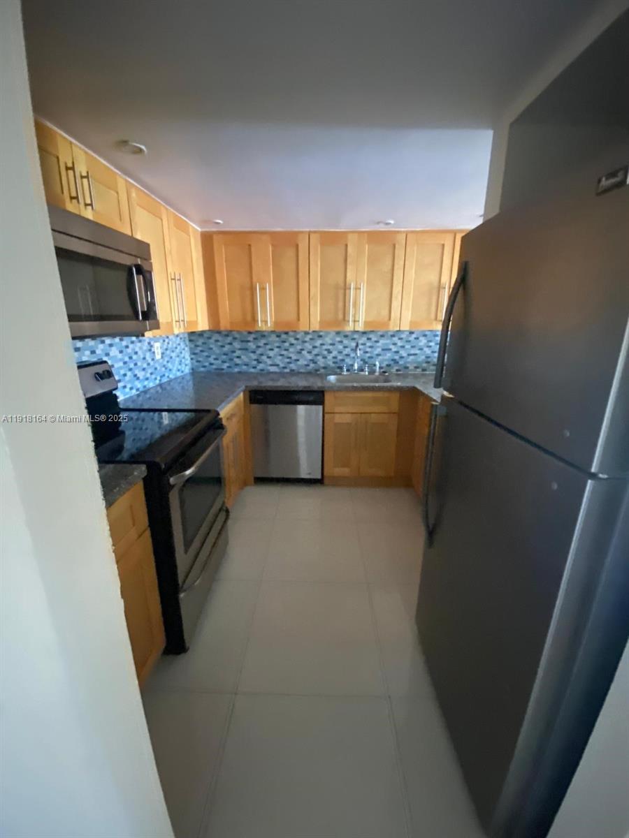 6970 Northwest 186th Street, Unit 3410 Hialeah, FL 33015 - Photo 5 of 10 a kitchen with a sink appliances and cabinets