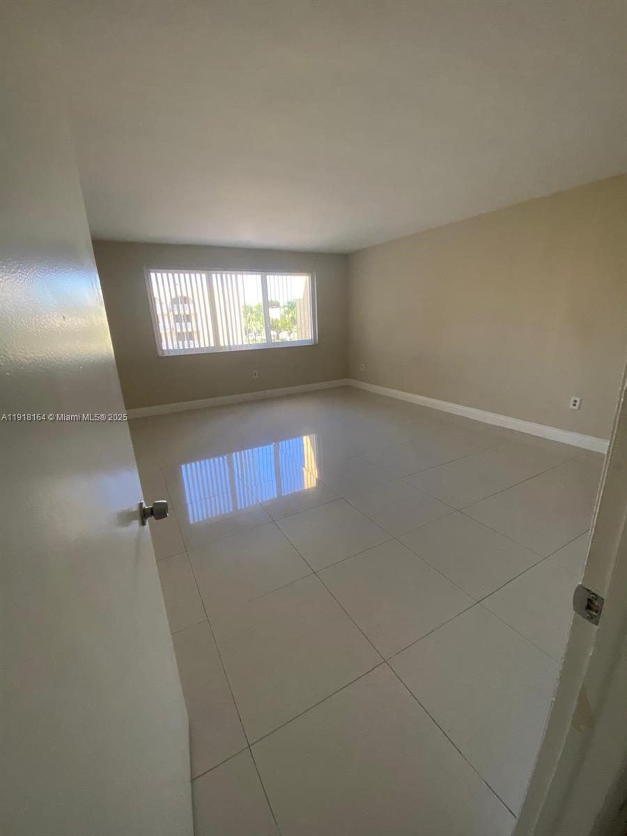6970 Northwest 186th Street, Unit 3410 Hialeah, FL 33015 - Photo 7 of 10 a view of an empty room and window