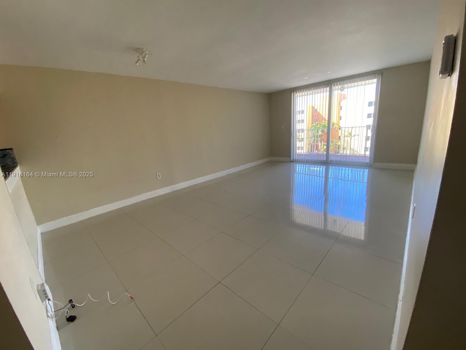 6970 Northwest 186th Street, Unit 3410 Hialeah, FL 33015 - Photo 9 of 10 a view of an empty room with a window