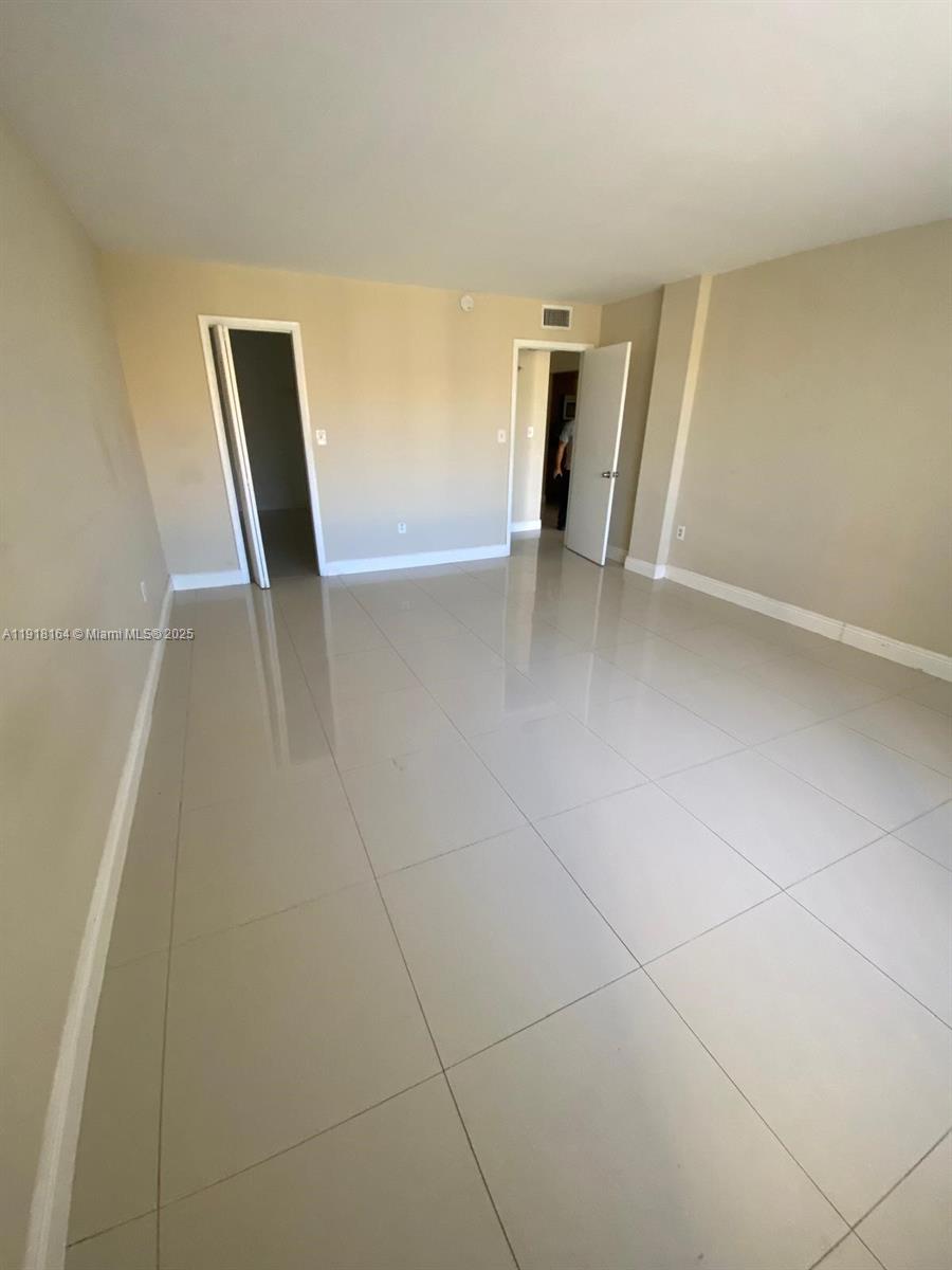 6970 Northwest 186th Street, Unit 3410 Hialeah, FL 33015 - Photo 10 of 10 wooden floor in an empty room with a window