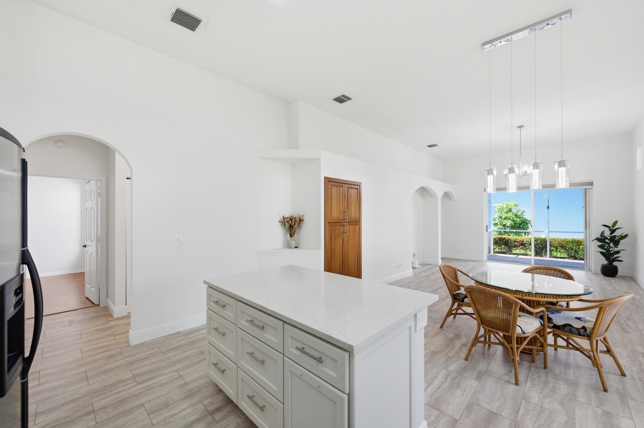 8534 Vía D Oro Boca Raton, FL 33433 - Photo 11 of 34 a kitchen with a table and chairs in it