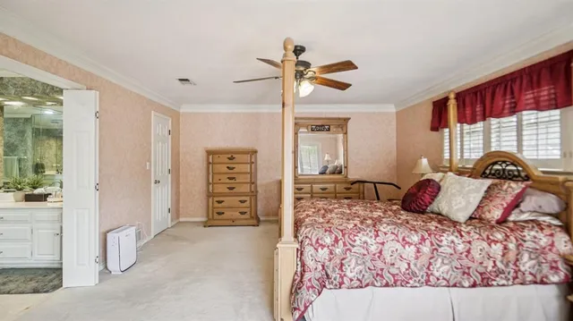 a bedroom with a large bed and a window