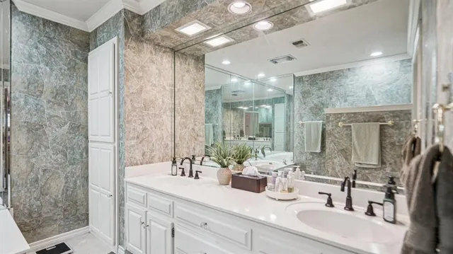 a bathroom with a double vanity sink mirror and shower