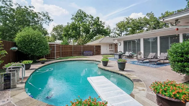 a view of a swimming pool with furniture