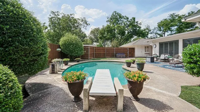 a view of a backyard with sitting area