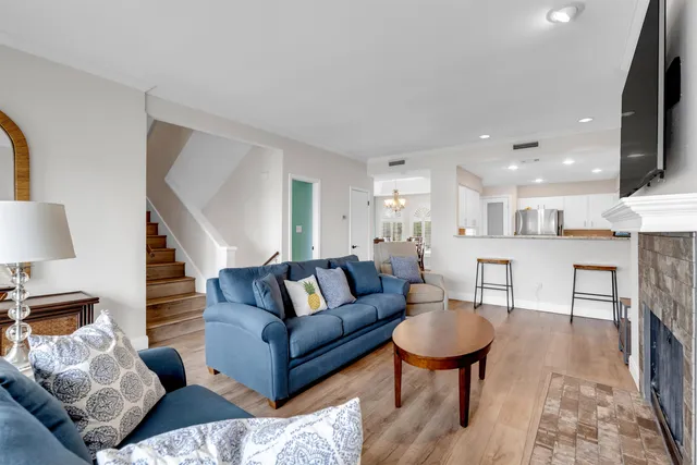 a living room with furniture a wooden floor and a fireplace