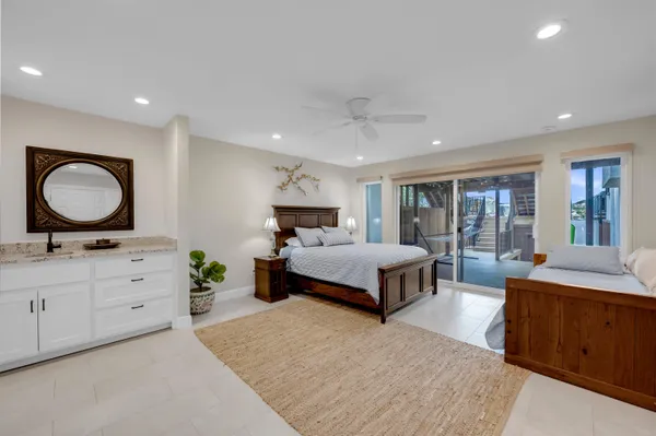 a spacious bedroom with a large bed and a dresser