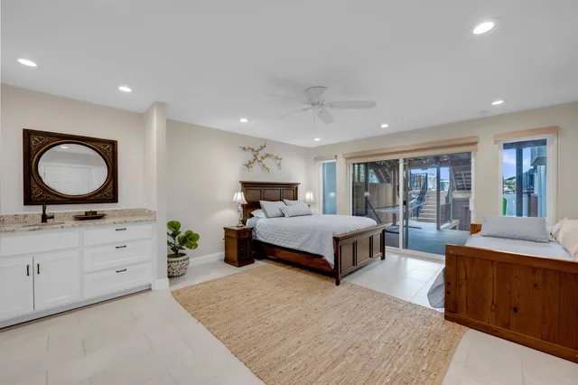 a spacious bedroom with a large bed and a dresser