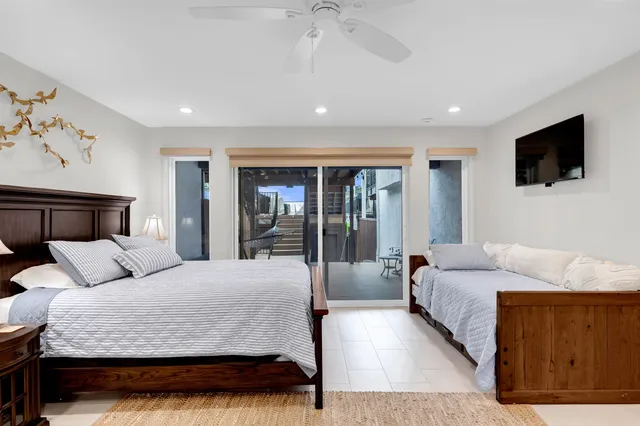 a bedroom with a large bed and a chandelier