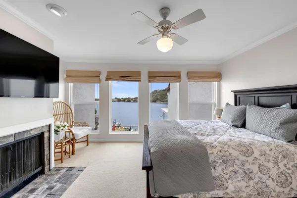 a bedroom with a bed window and a flat screen tv