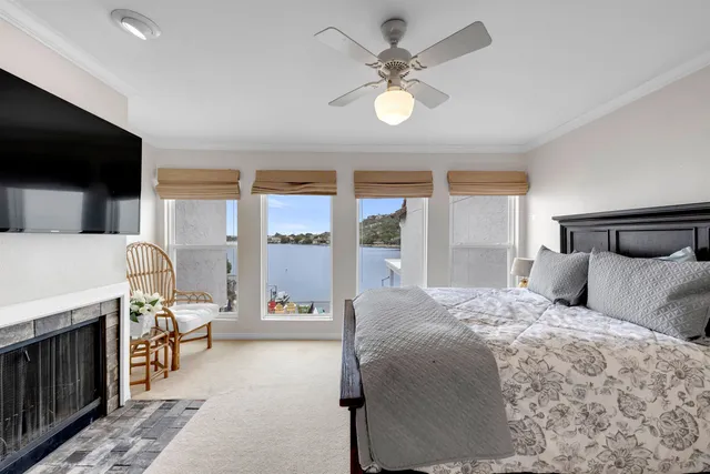 a bedroom with a bed window and a flat screen tv