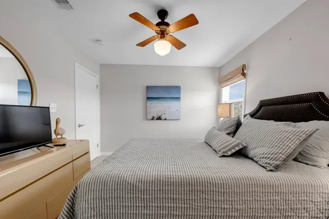 a bedroom with a bed and a flat screen tv