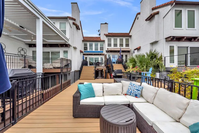 a balcony with furniture and wooden floor