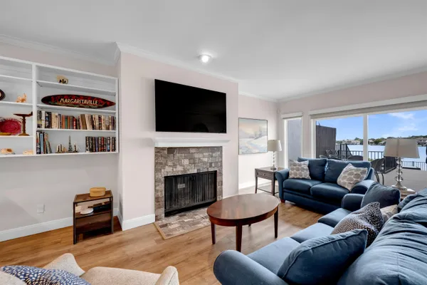 a living room with furniture a fireplace and a flat screen tv