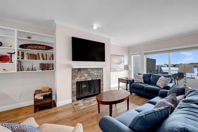 a living room with furniture a fireplace and a flat screen tv