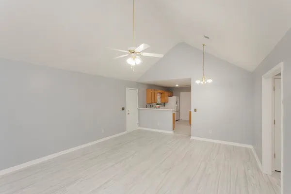 wooden floor in an empty room with a kitchen