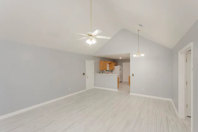 wooden floor in an empty room with a kitchen
