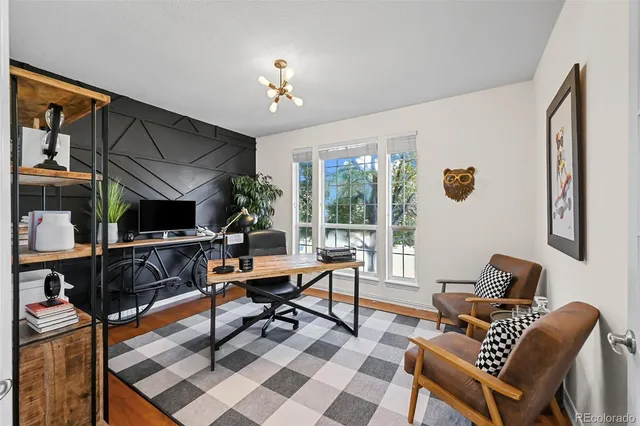 a living room with furniture a rug and a chandelier