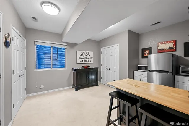 a kitchen with stainless steel appliances a dining table and chairs