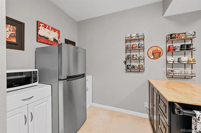 a kitchen with stainless steel appliances a refrigerator and a stove top oven