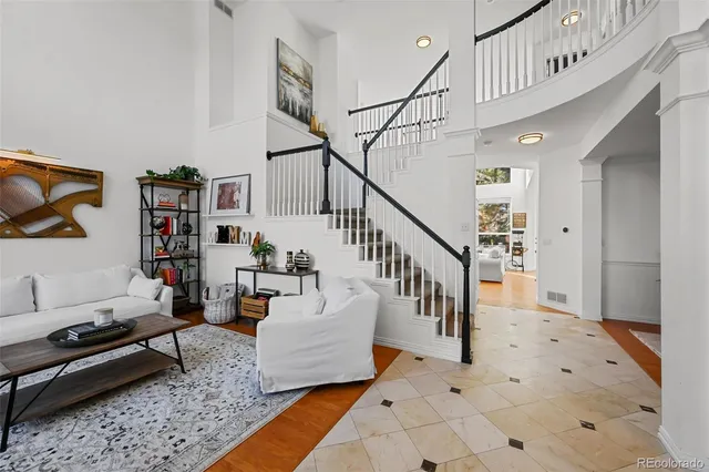 a living room with furniture and stairs