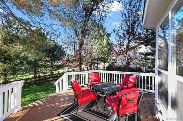 a view of a wooden deck with furniture