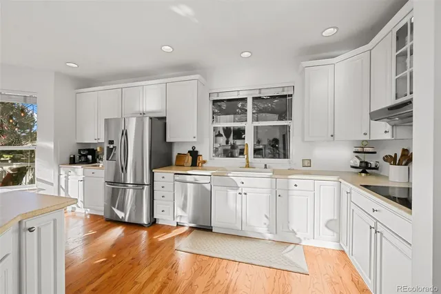 a kitchen with refrigerator cabinets and wooden floor