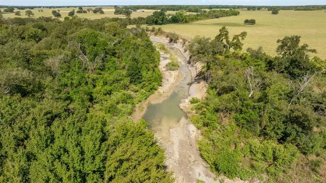 a view of a lake with a yard and mountain view