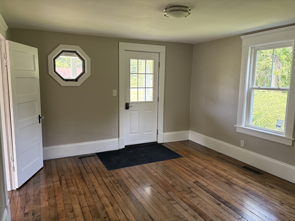 208 Greenfield Road Deerfield, MA 01373 - Photo 10 of 27 an empty room with wooden floor and windows