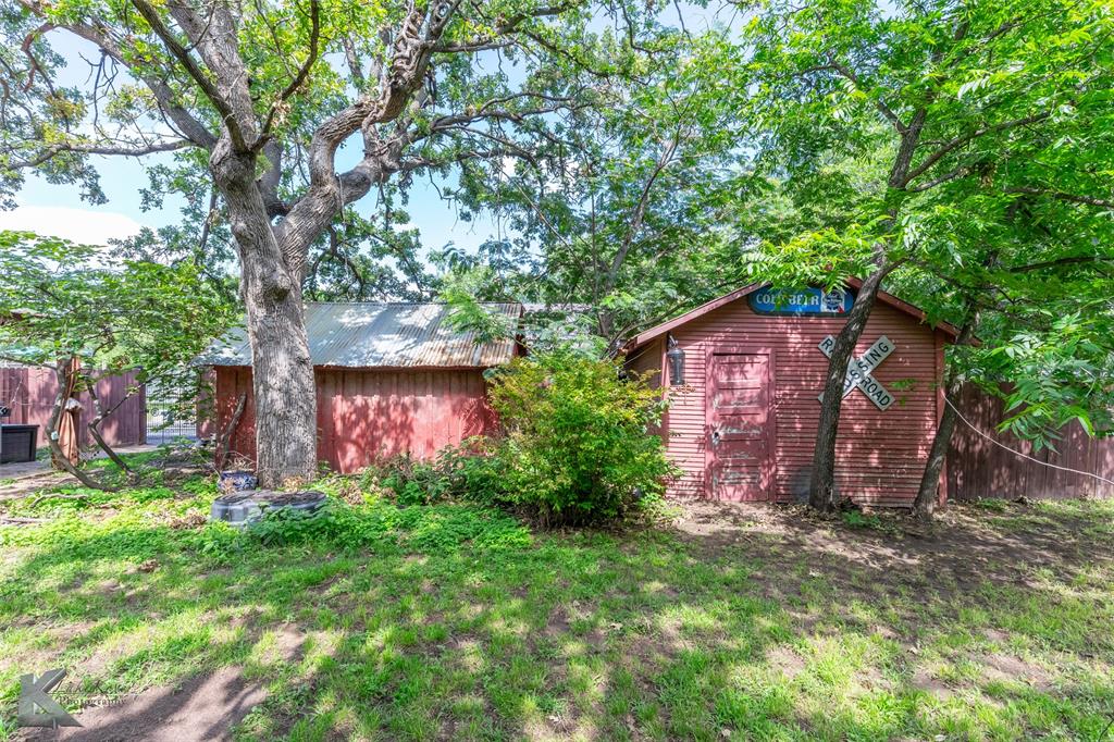 202 East Ross Street Rising Star, TX 76471 - Photo 35 of 40 a couple of table and a chairs in front of wooden house