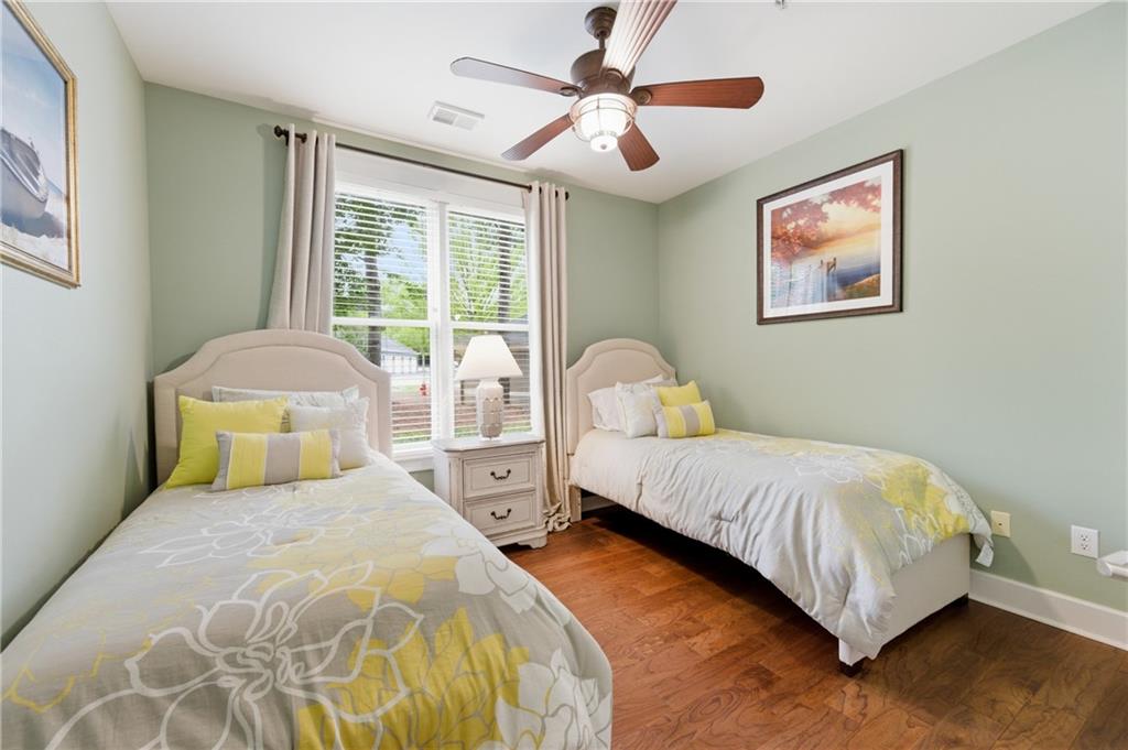 117 South Bay Road, Unit 402 Eatonton, GA 31024 - Photo 15 of 48 a bedroom with a bed and a chandelier