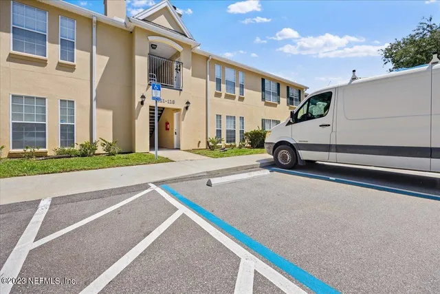 a car parked in front of a white building