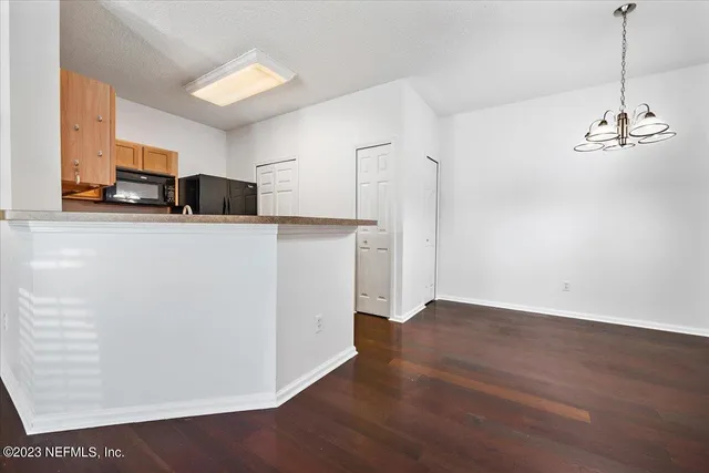 a kitchen with stainless steel appliances a refrigerator sink and microwave