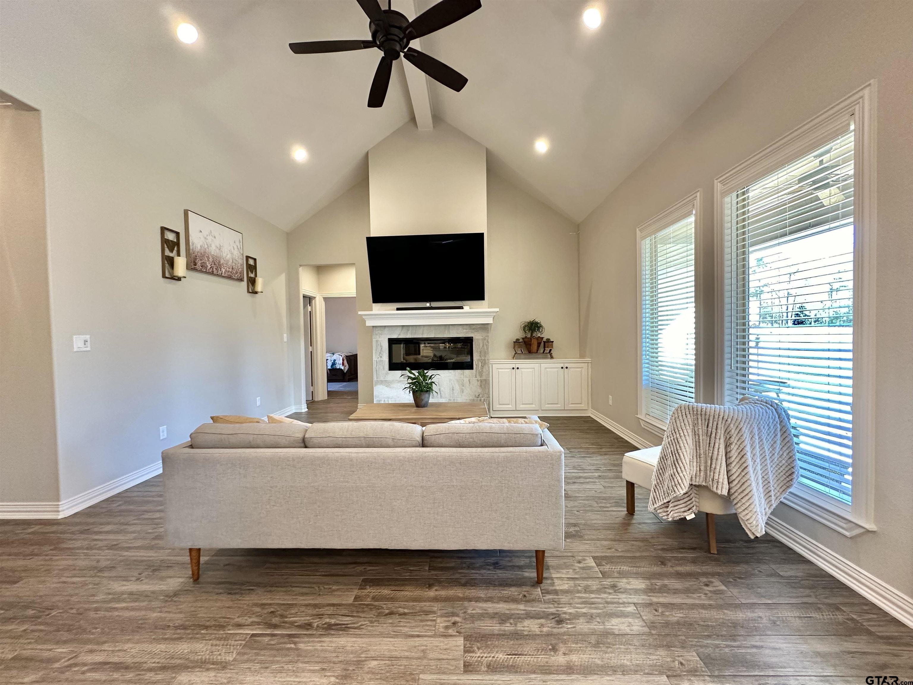 345 Willow Creek Ranch Road Gladewater, TX 75647 - Photo 11 of 47 a living room with furniture and a flat screen tv
