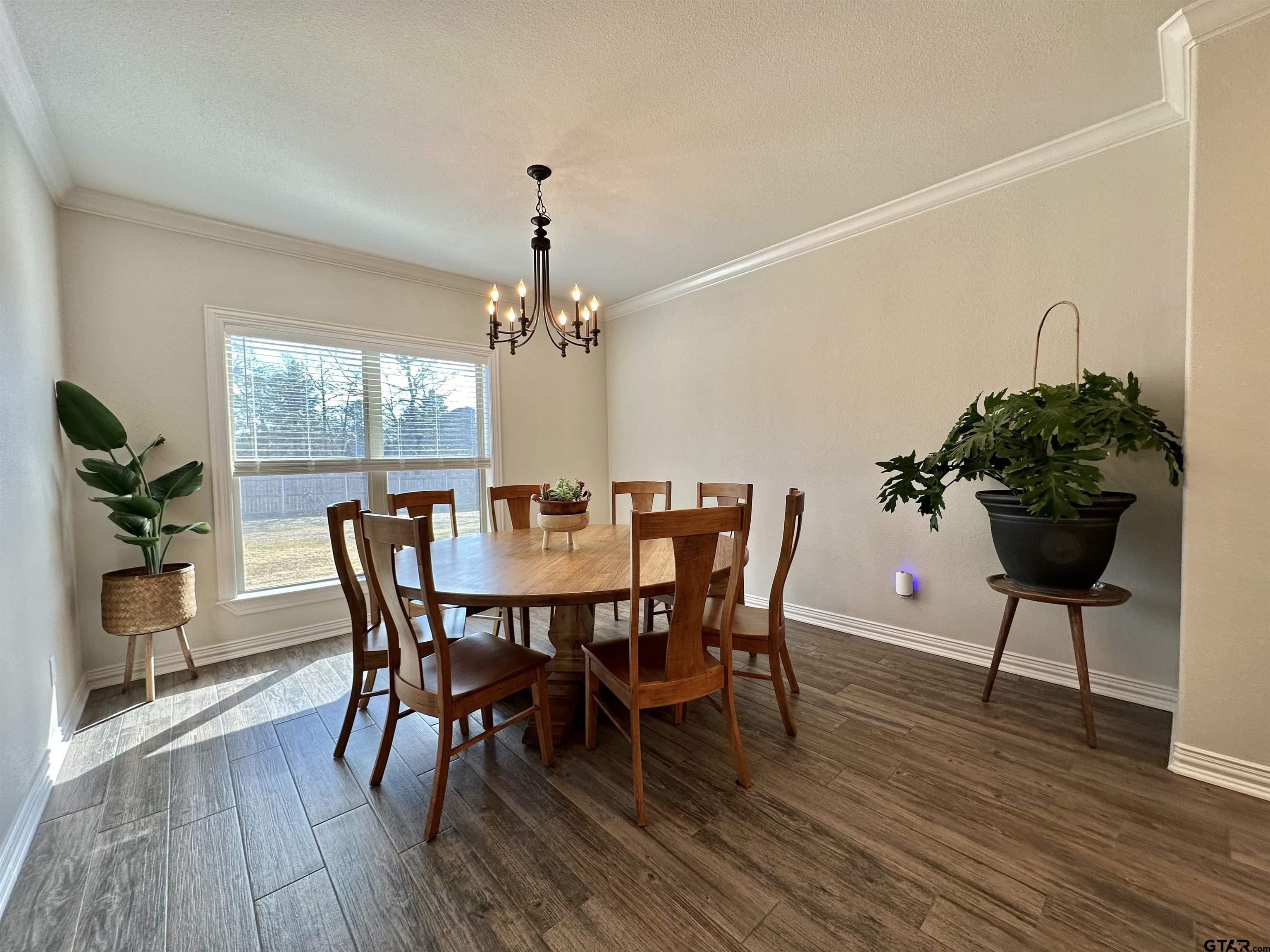 345 Willow Creek Ranch Road Gladewater, TX 75647 - Photo 18 of 47 a view of a dining room with furniture window and wooden floor