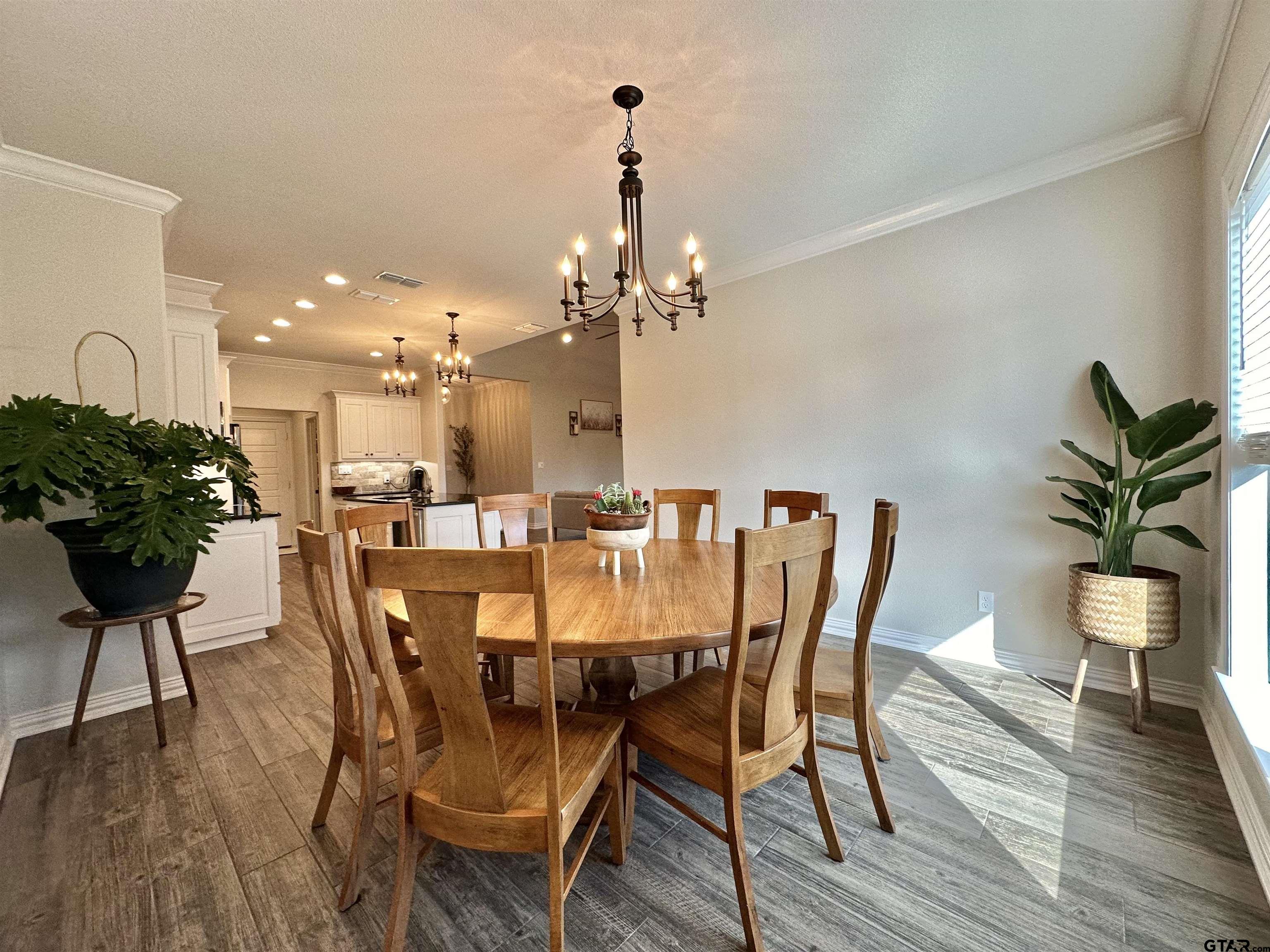 345 Willow Creek Ranch Road Gladewater, TX 75647 - Photo 19 of 47 a view of a dining room with furniture and wooden floor