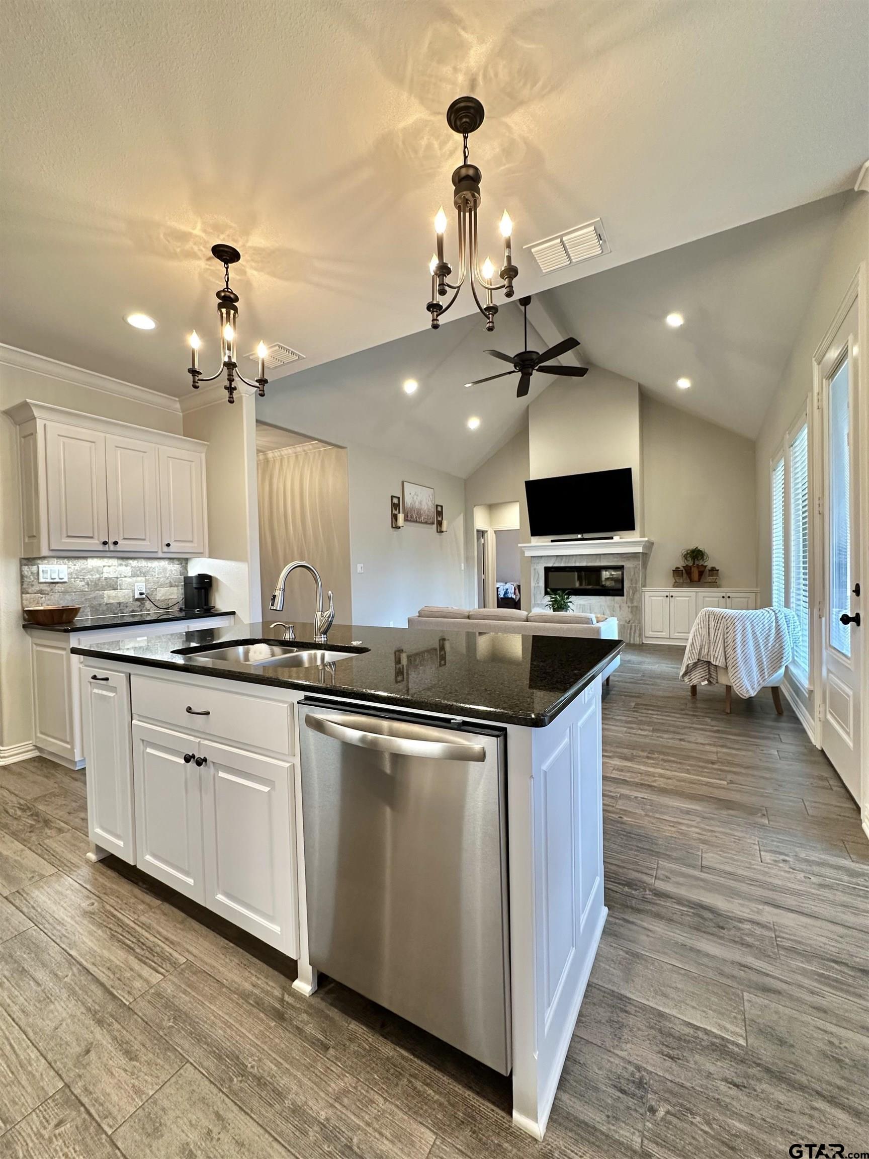 345 Willow Creek Ranch Road Gladewater, TX 75647 - Photo 20 of 47 a kitchen with stainless steel appliances kitchen island granite countertop a sink and a stove