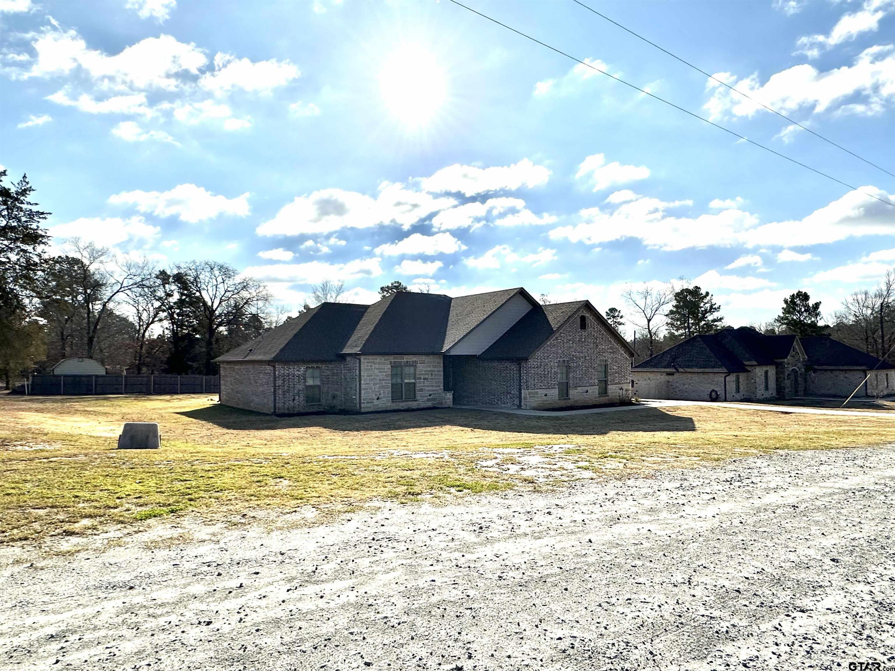 345 Willow Creek Ranch Road Gladewater, TX 75647 - Photo 2 of 47 a view of a swimming pool with an outdoor space and seating area
