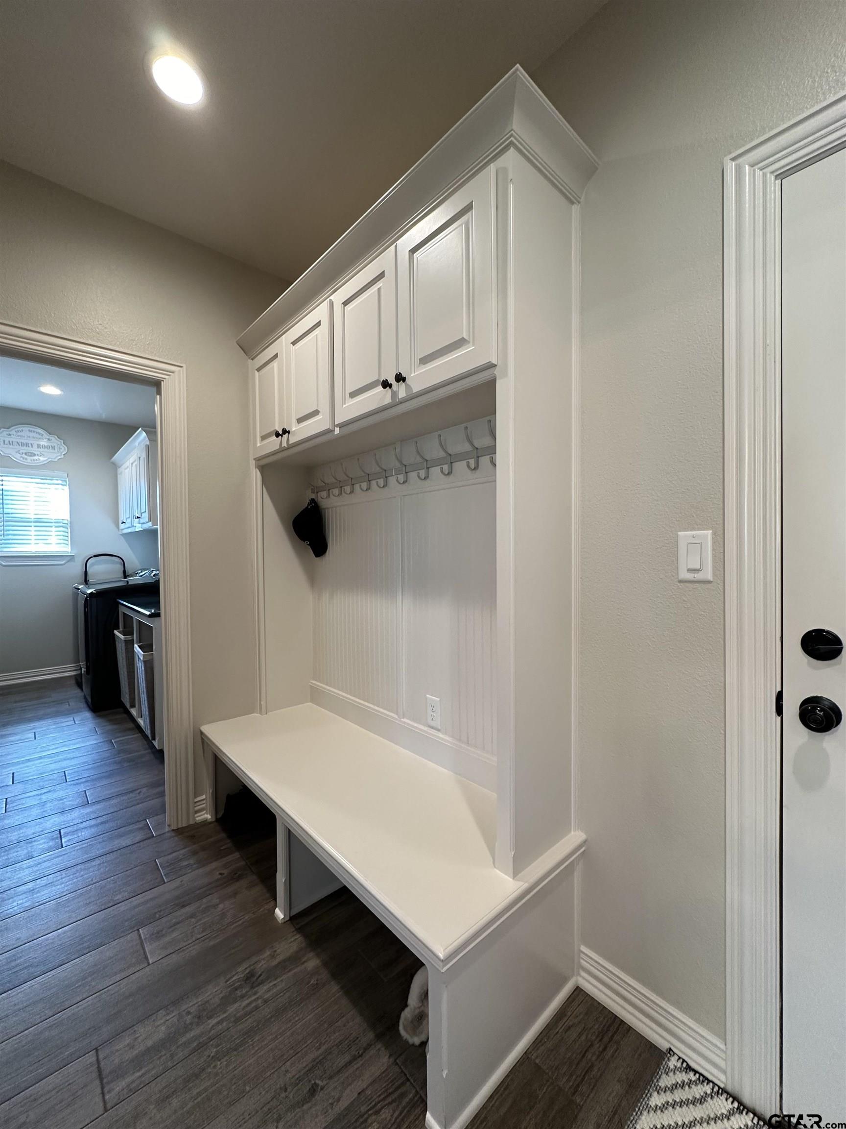 345 Willow Creek Ranch Road Gladewater, TX 75647 - Photo 24 of 47 a hallway view with wooden floor and staircase