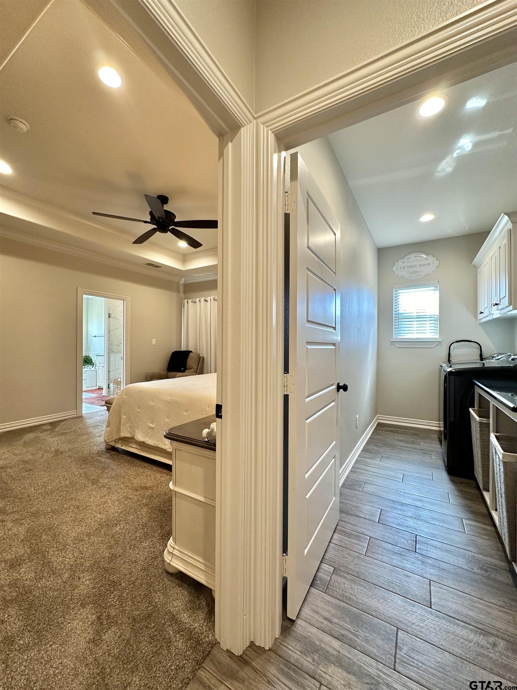 345 Willow Creek Ranch Road Gladewater, TX 75647 - Photo 26 of 47 a bedroom with a bed and wooden floor