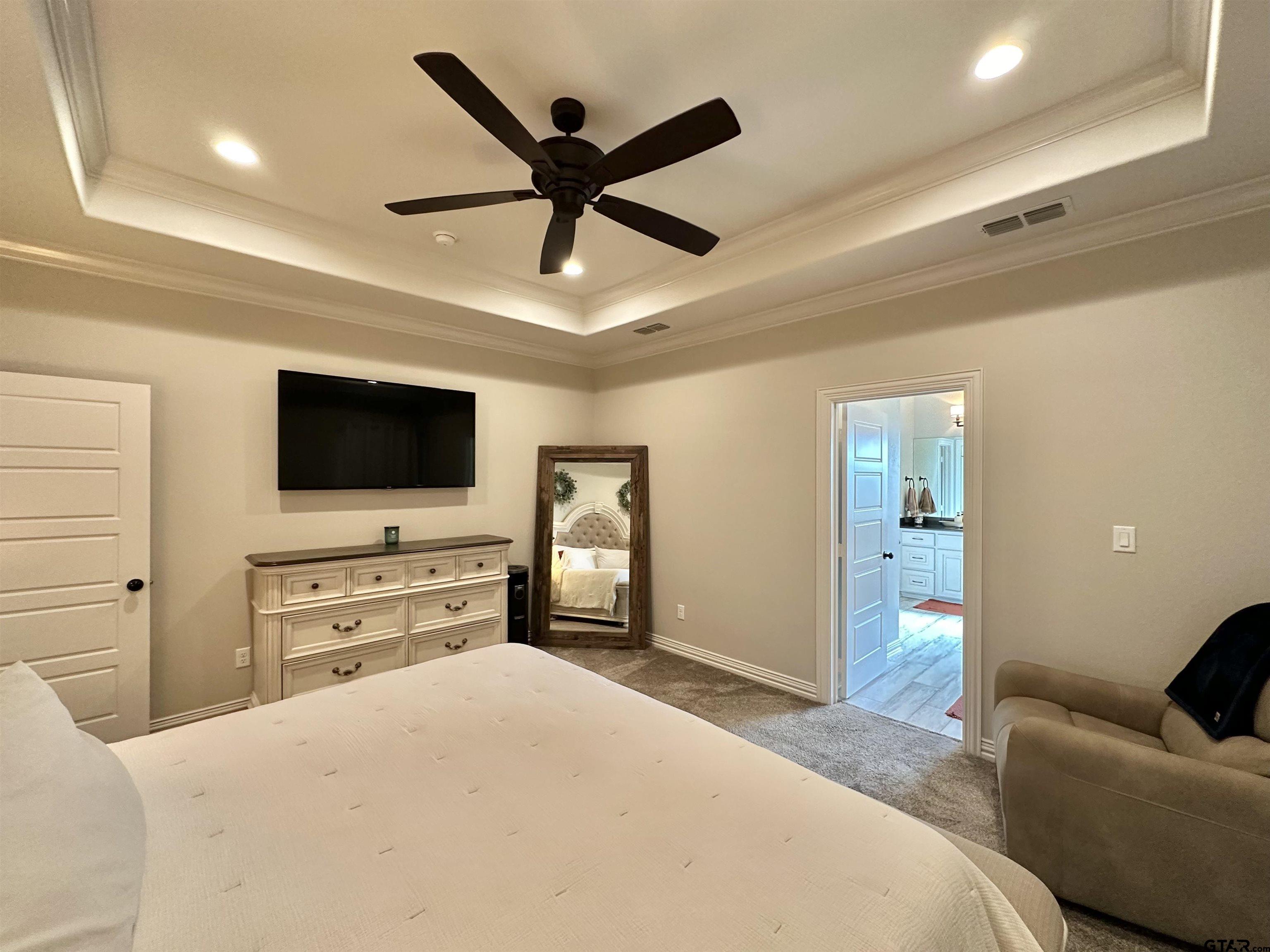 345 Willow Creek Ranch Road Gladewater, TX 75647 - Photo 30 of 47 a bedroom with a bed and a flat screen tv
