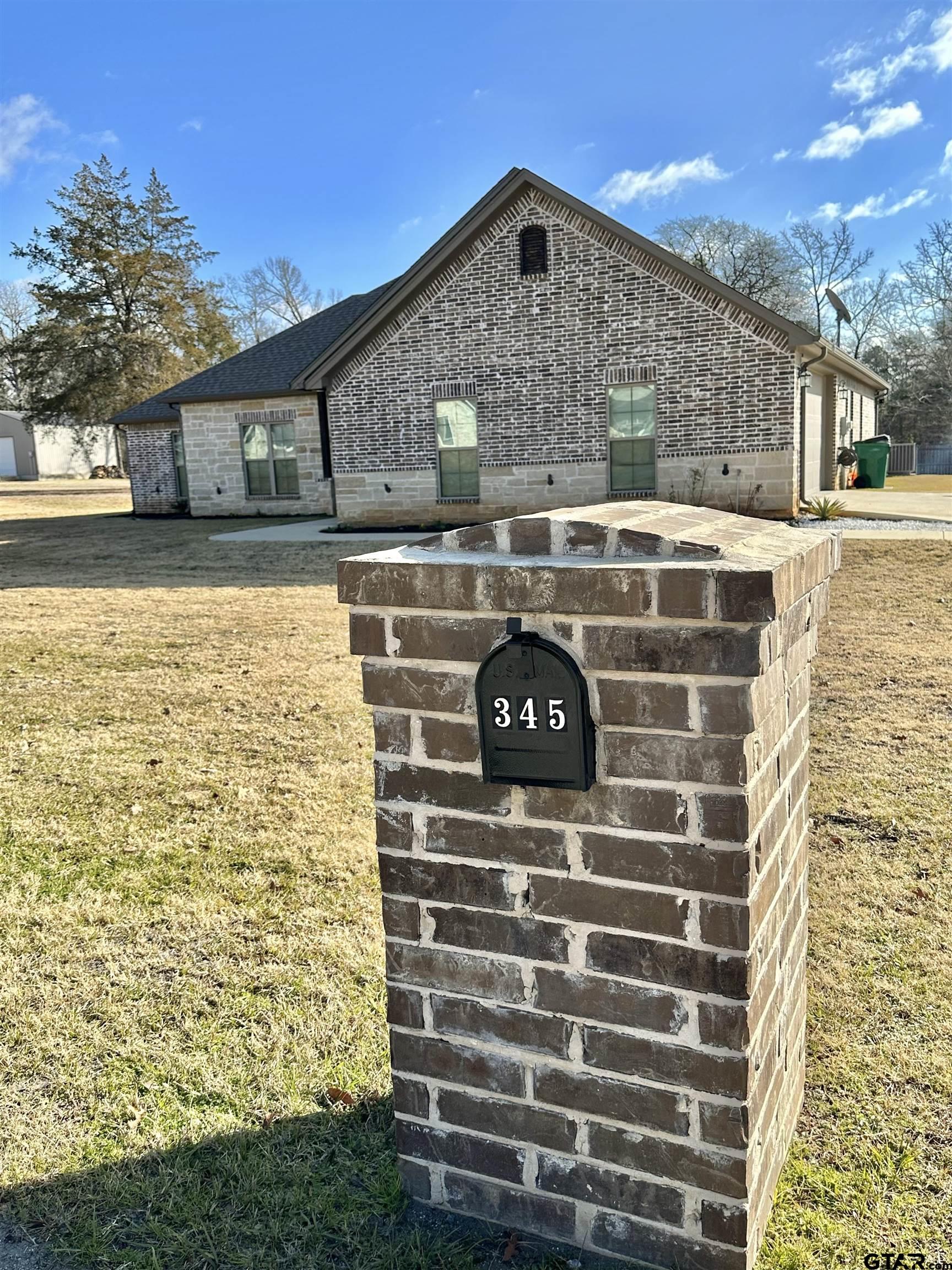 345 Willow Creek Ranch Road Gladewater, TX 75647 - Photo 3 of 47 a front view of a house with a yard