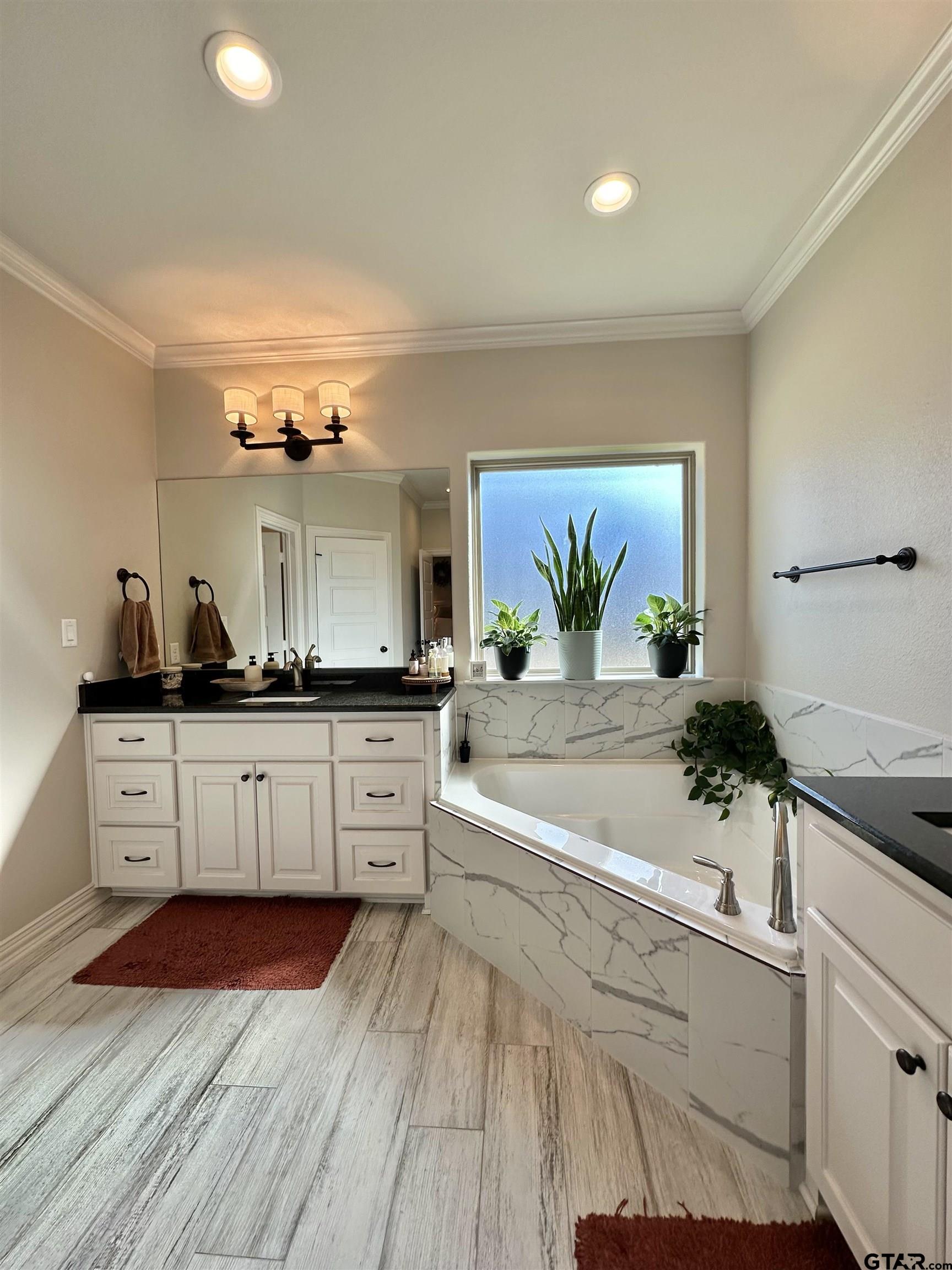 345 Willow Creek Ranch Road Gladewater, TX 75647 - Photo 32 of 47 a spacious bathroom with double vanity and a mirror