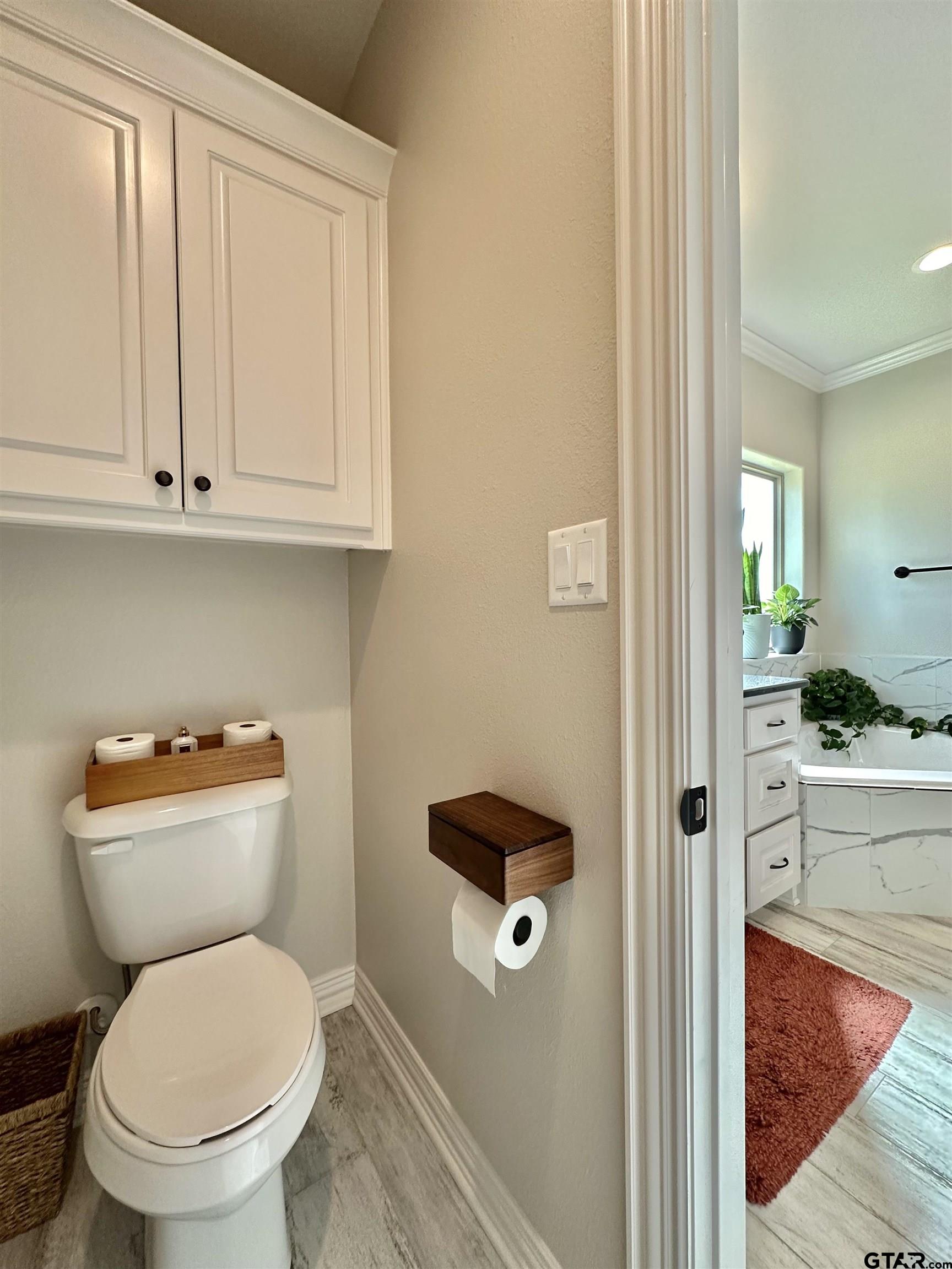 345 Willow Creek Ranch Road Gladewater, TX 75647 - Photo 35 of 47 a white toilet sitting next to a bathroom sink